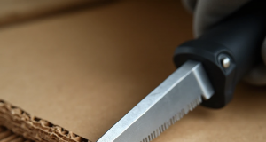🎨 How to cut cardboard flat: tools and techniques for perfect edges Professional cardboard knife with serrated blade cuts through thick corrugated cardboard